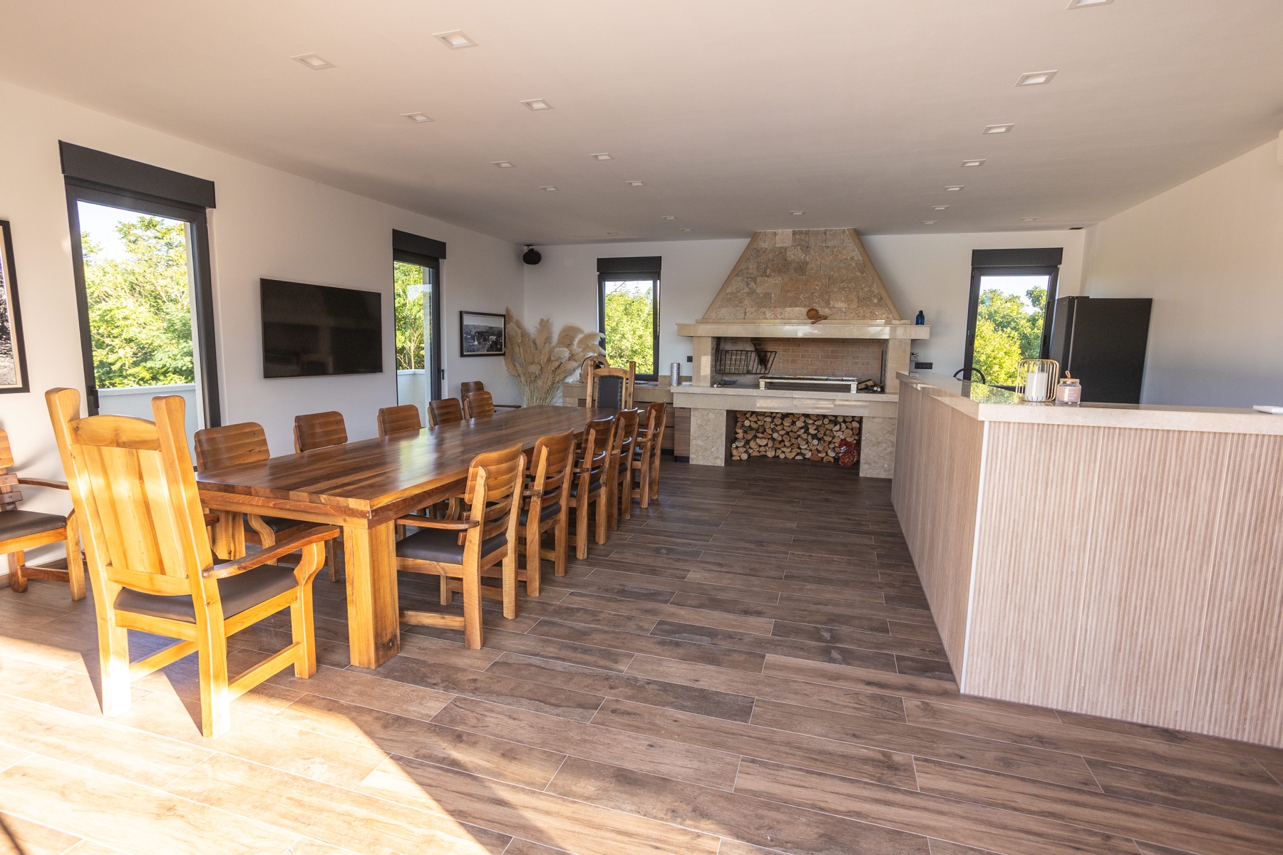 Spacious barbecue house with fireplace and dining table